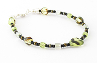Green and brown bracelet with focus heart bead